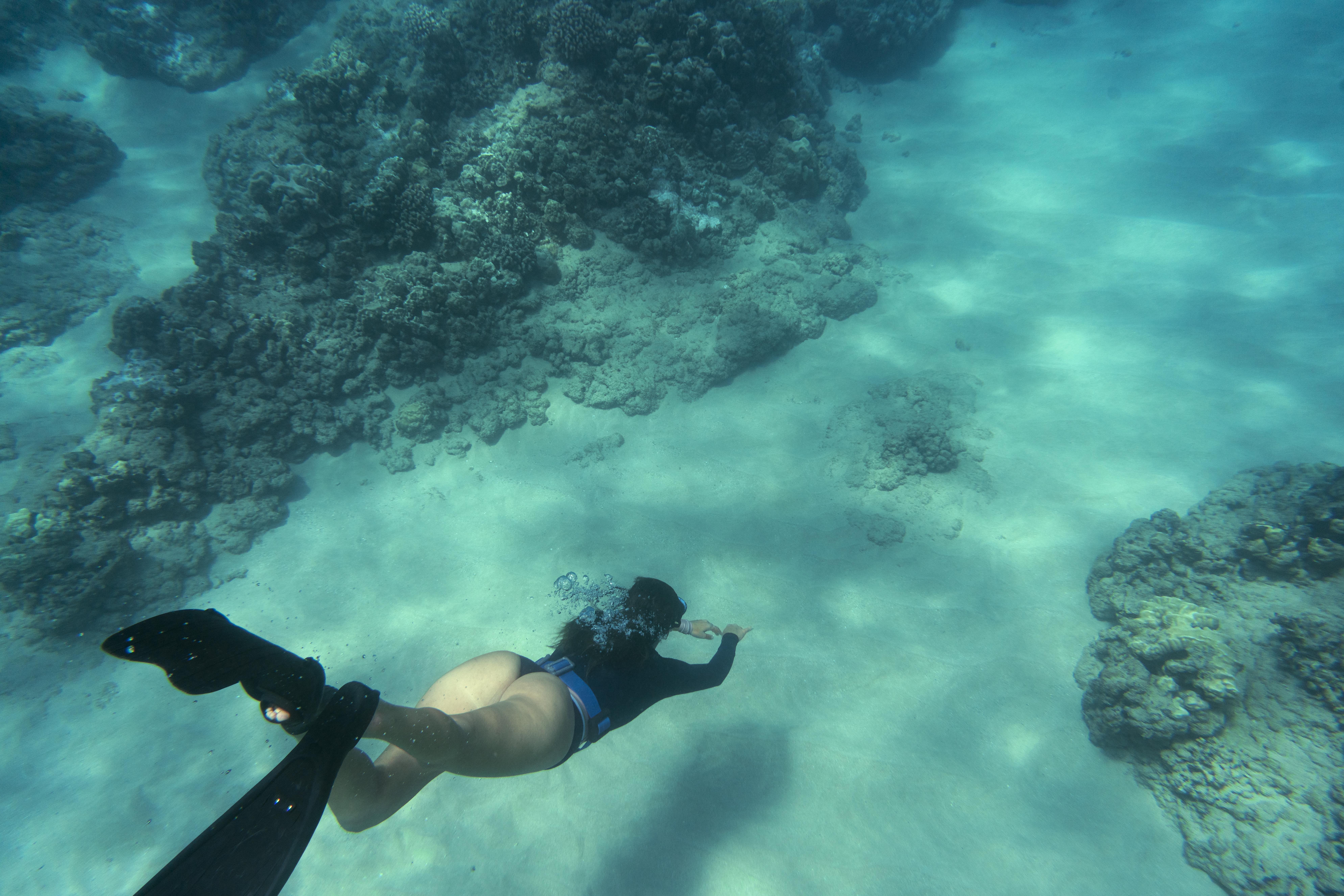 woman-freediving-with-flippers-underwater